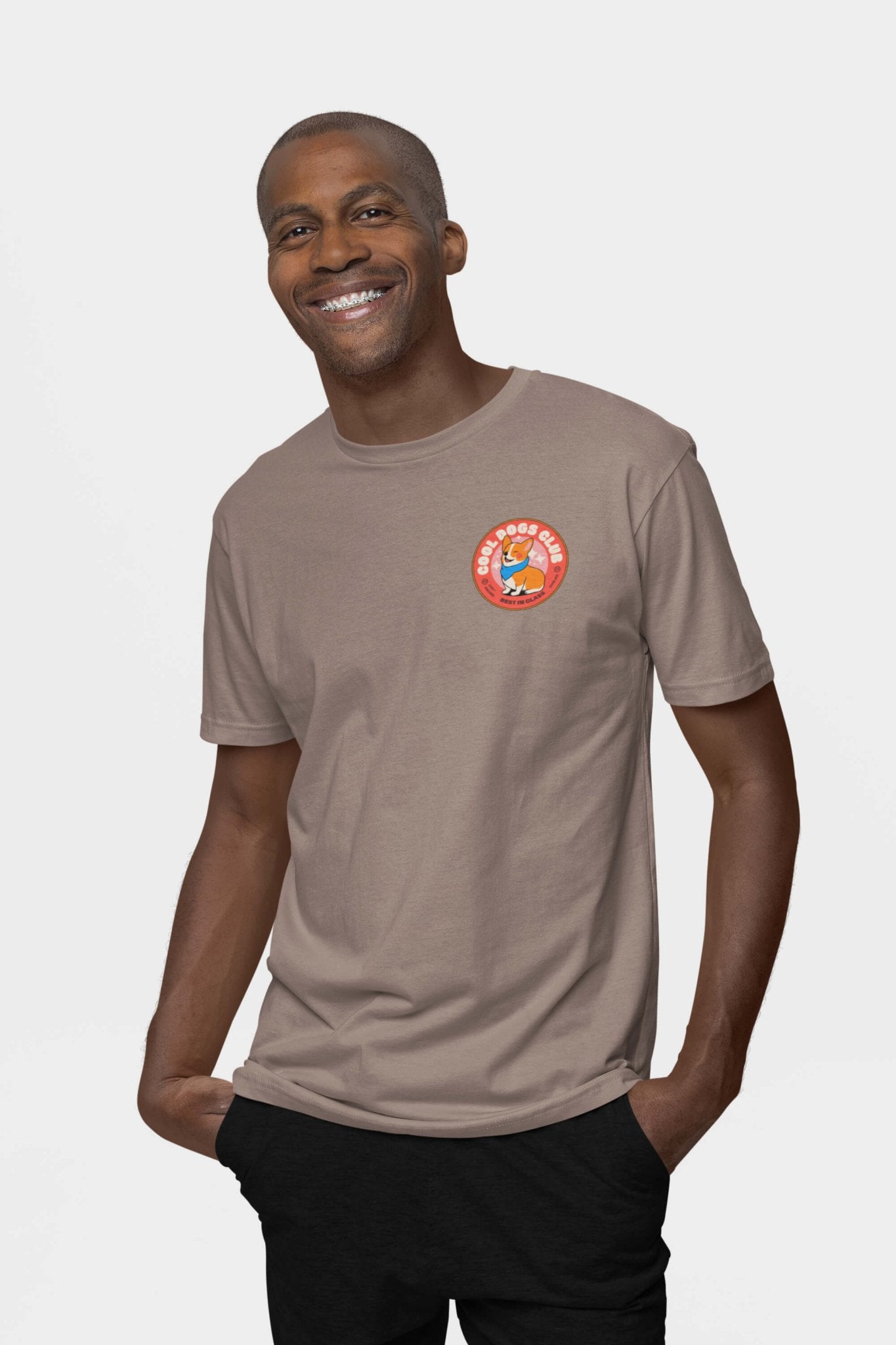 Radiating happiness, they wear the Cool Dogs Club Unisex Hype T-Shirt from Dogloverclothing.com in beige, showcasing the vibrant circular logo on the left chest, ideal for dog lovers, against a crisp white backdrop.