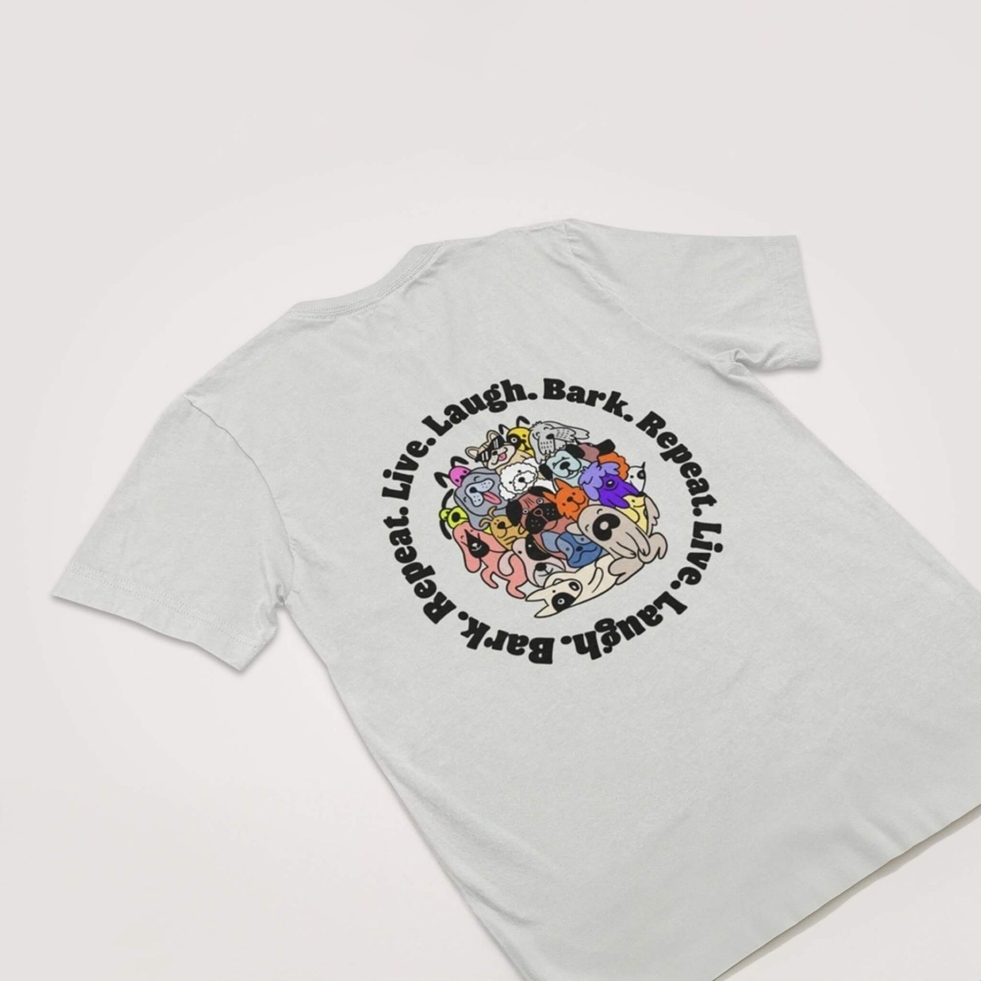 The Dogloverclothing.com Live Laugh Bark Repeat Unisex T-Shirt is shown flat, with a colorful cartoon dog graphic and Live. Laugh. Bark. Repeat. in bold black on the back—ideal for any dog lover.