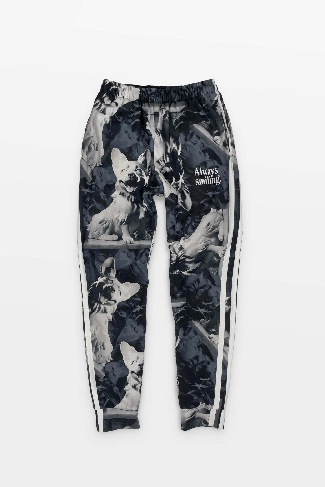 The Corgi Supreme Tribute Joggers from Dogloverclothing.com are black with a repeated wolf design and Always Smiling text on the upper left. Made from recycled materials, they feature white side stripes for a stylish, sustainable look.
