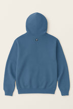 The Dog Mom Hoodie by Dogloverclothing.com is shown from the back, with a small round black and white paw-print logo below the hood, set against a plain light background.