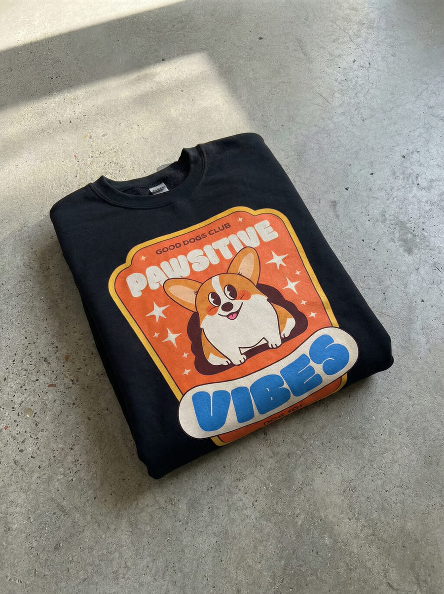 Black Pawsitive Vibes Corgi Sweatshirt from WOOF folded, showing the heavyweight fabric