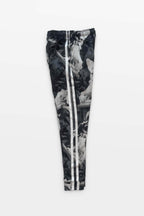 Corgi Supreme Tribute Joggers by Dogloverclothing.com are black and white athleisure pants with a camo-style print featuring artistic statue imagery. Made from recycled materials, they have two white stripes down the sides and are set against a plain white background.