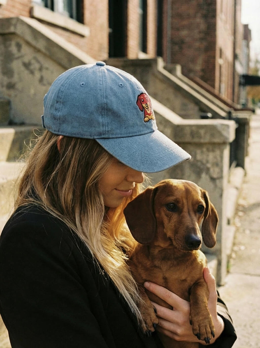 Side view of the blue Dachshund embroidered denim cap from WOOF