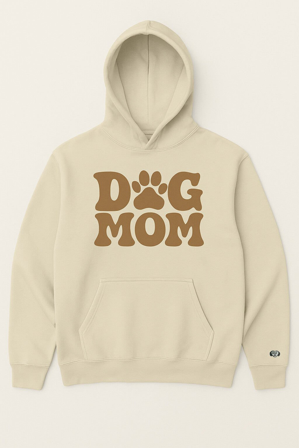 The Dog Mom Hoodie by Dogloverclothing.com is a beige hoodie with a front pocket, hood, large brown Dog Mom text, and a paw-print replacing the O in DOG.