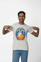 A person wears a Best Dog Supreme Tribute Unisex T-Shirt from Dogloverclothing.com. It features a premium cotton light-colored tee with an oval corgi design and Sit, Stay, Slay and Best Dog text. Smiling, they point at this must-have for dog lovers.