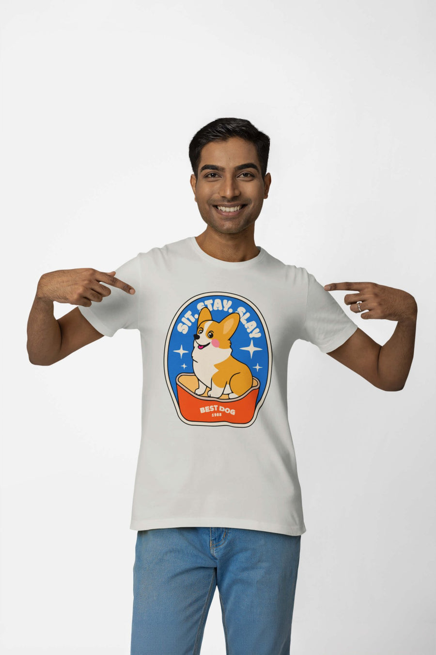 Smiling person pointing at the corgi badge on the Best Dog T-Shirt from WOOF