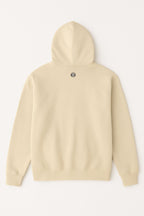 Dogloverclothing.coms Dog Mom Hoodie in beige features long sleeves, ribbed cuffs and hem, and a small black-and-white paw-print patch below the hood on the back.