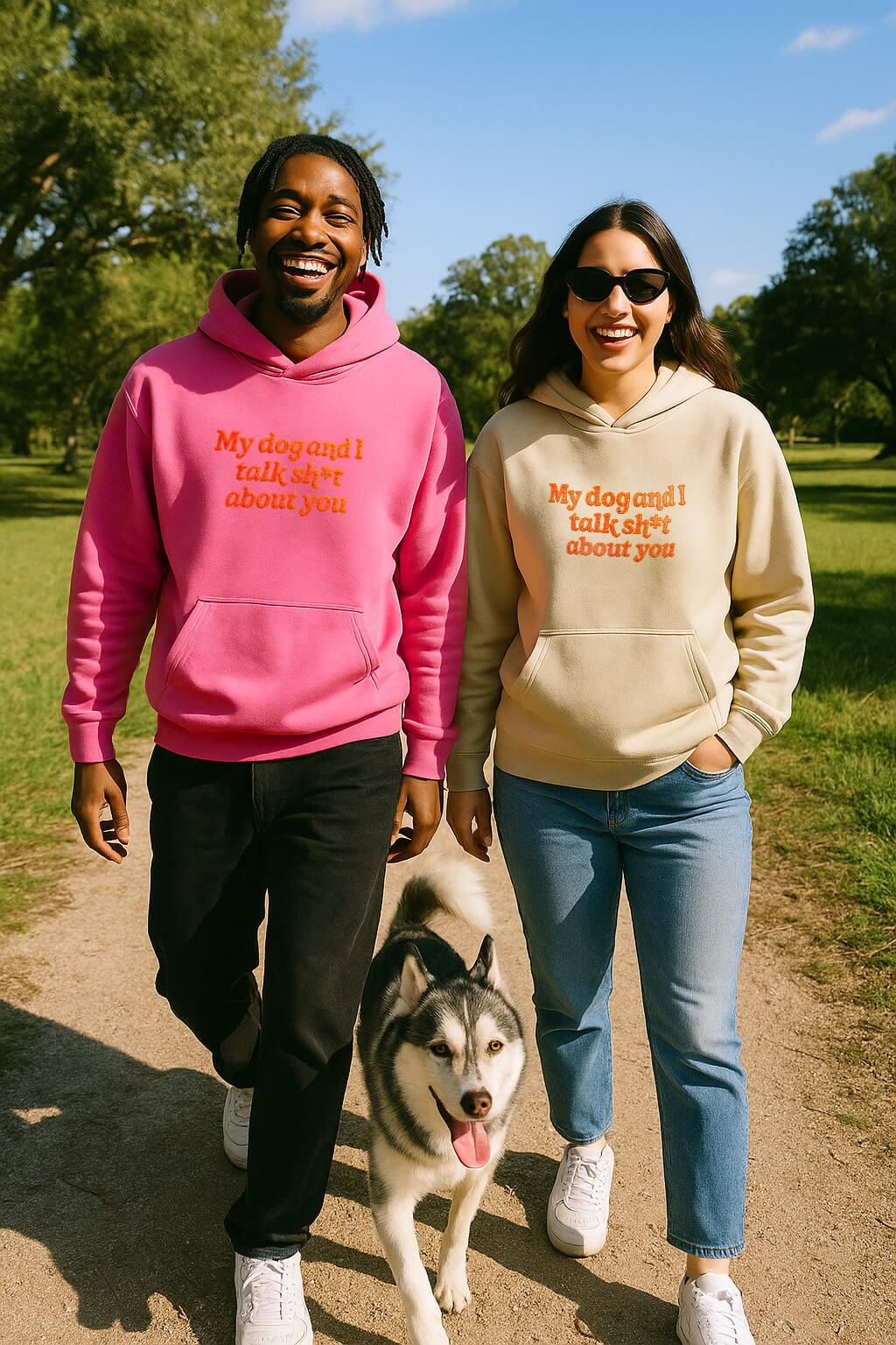 A smiling couple walks outside with a husky, wearing Bold My Dog And I Talk Embroidered Hoodies from Dogloverclothing.com—premium sweatshirts with “My dog and I talk sh*t about you” embroidered on the front.