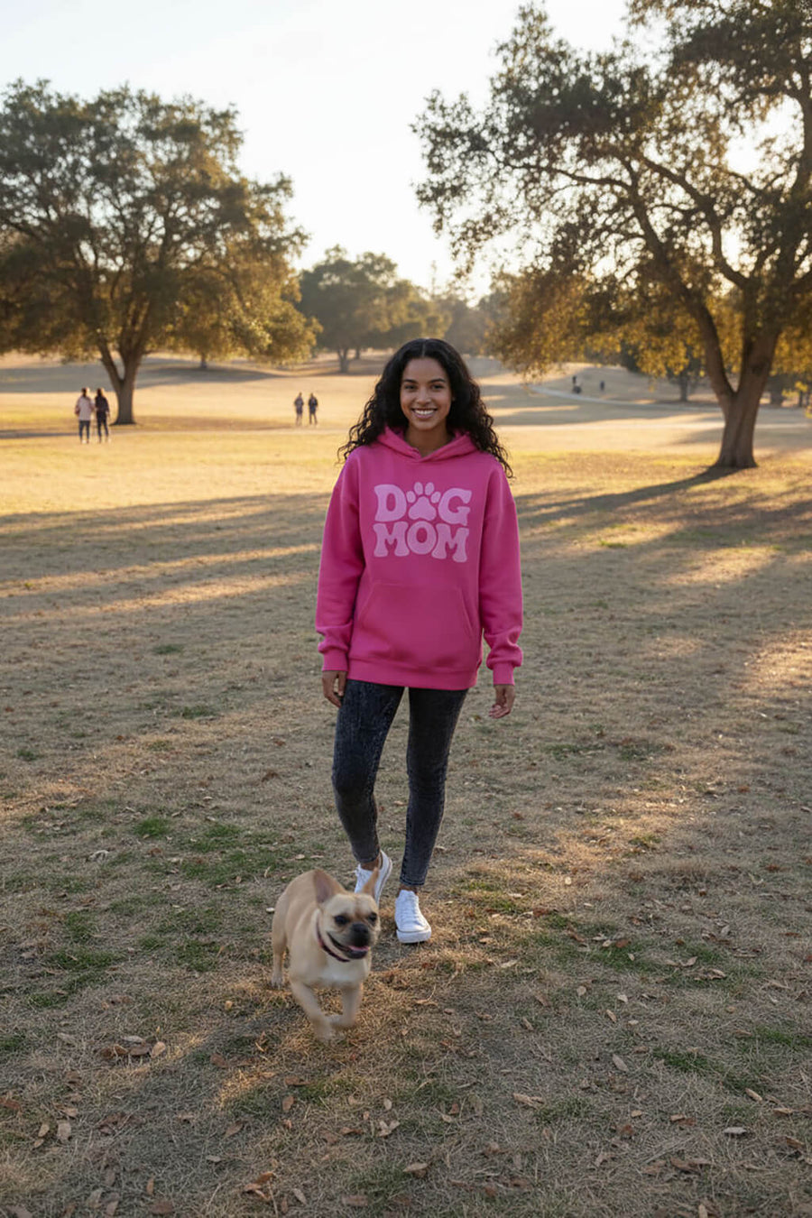 Model wearing the pink Dog Mom Hoodie from WOOF in an everyday setting