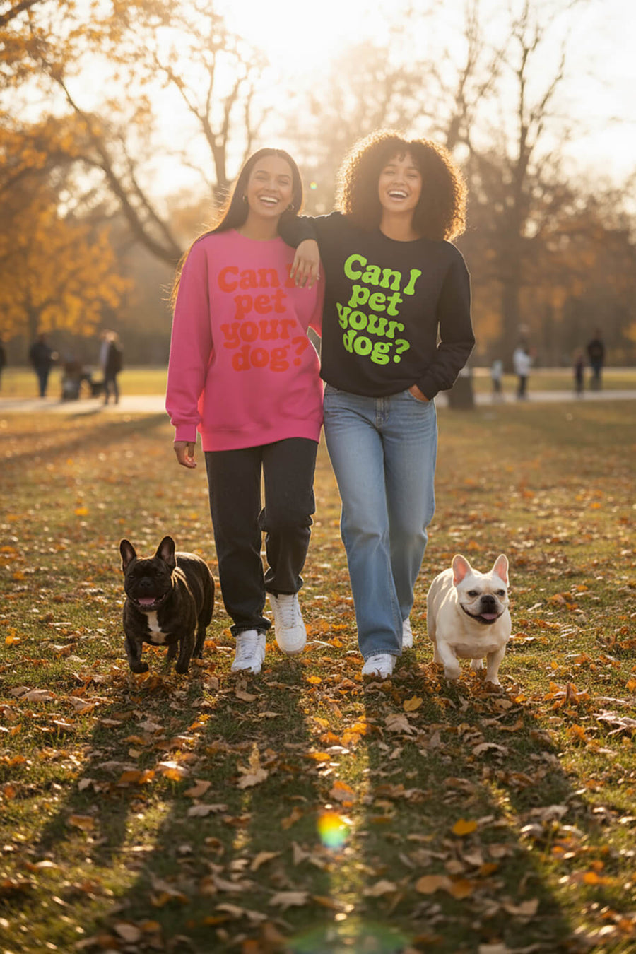 Two people wearing Can I Pet Your Dog Sweatshirts from WOOF in pink and black