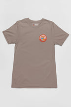 Dogloverclothing.coms Cool Dogs Club Unisex Hype T-Shirt is khaki with a circular patch on the left chest, featuring a colorful cartoon character and the words Keep Going Keep Growing. Ideal for dog lovers and Cool Dogs Club members.