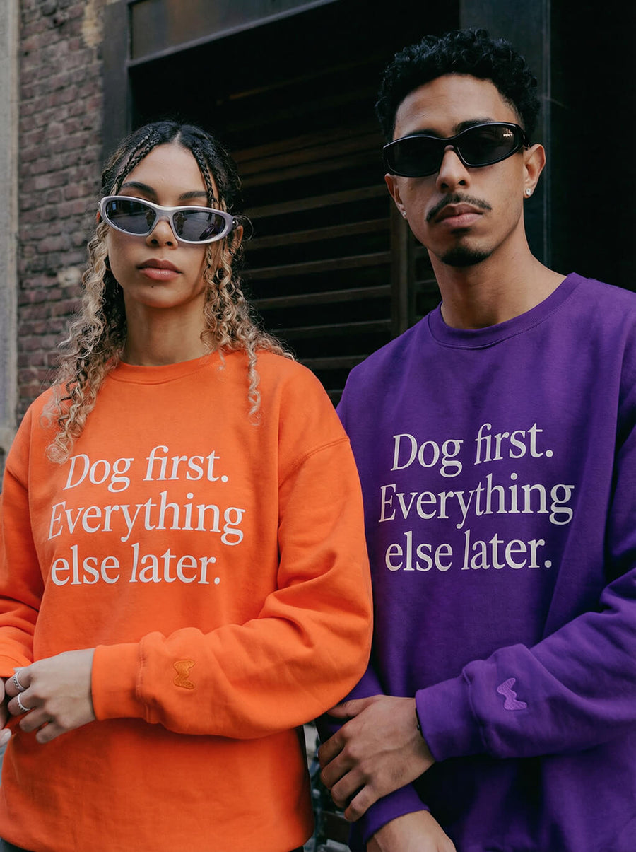 Dog First Statement Sweatshirts from WOOF in orange and purple side by side