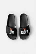 The Mighty Corgi Rider Slides from Dogloverclothing.com are black, durable sandals with LOW on the left and RIDER on the right, each displaying a small cartoon corgi face above the text.