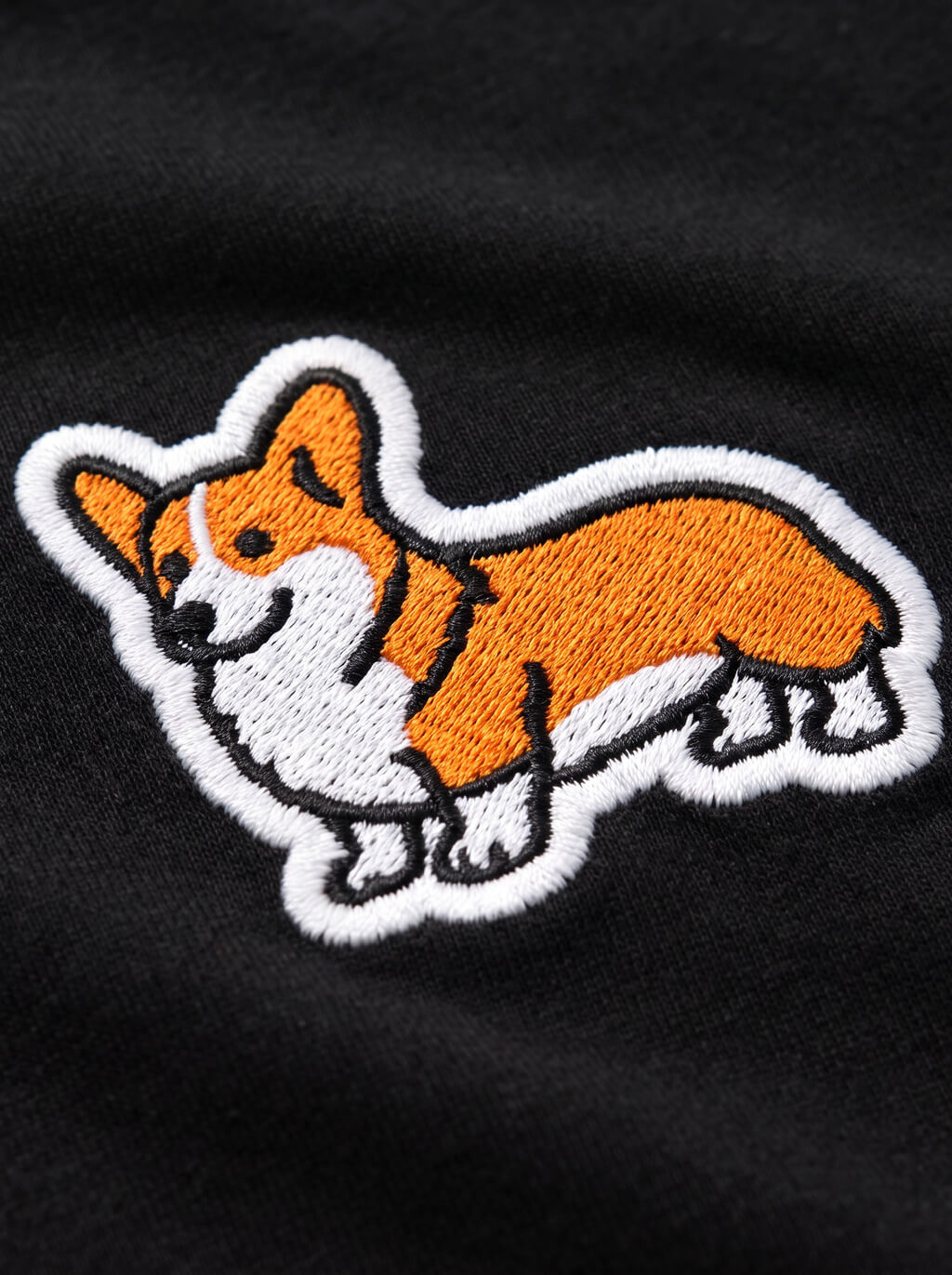 Close up of the corgi patch on the black embroidered T-Shirt from WOOF