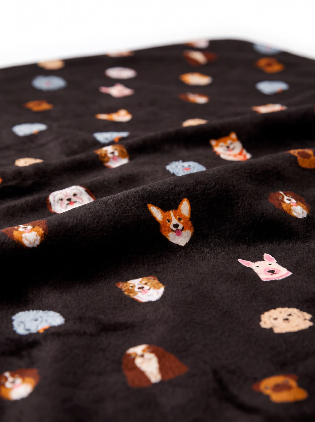 Close up of the print on the black Doggy Dreams Sherpa Dog Blanket from WOOF