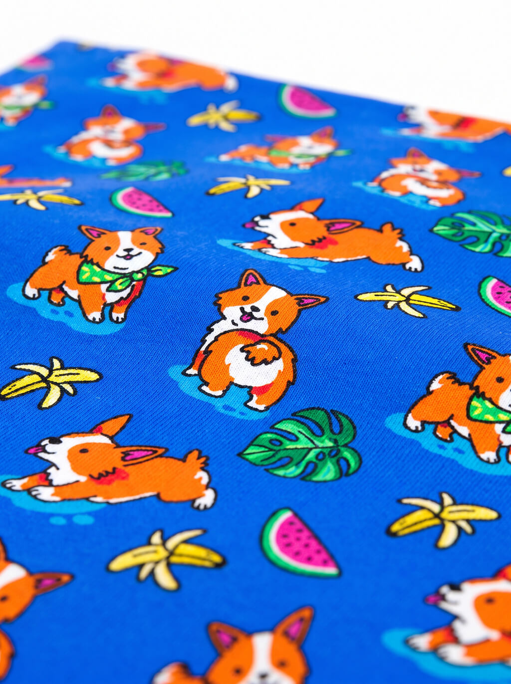 Close up of the tropical print on the blue corgi dog bandana from WOOF