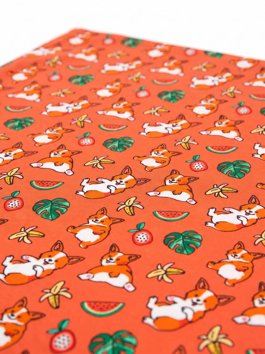 Close up of the tropical print on the orange corgi dog bandana from WOOF