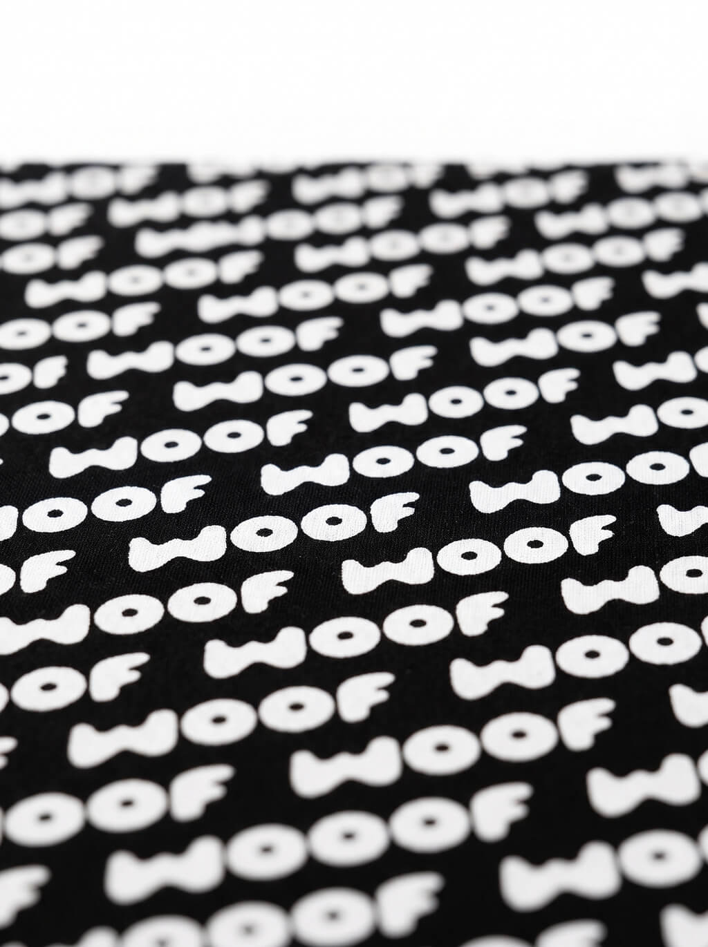 Close up of the WOOF logo on the black dog bandana