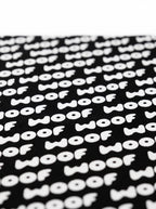 Close up of the WOOF logo on the black dog bandana