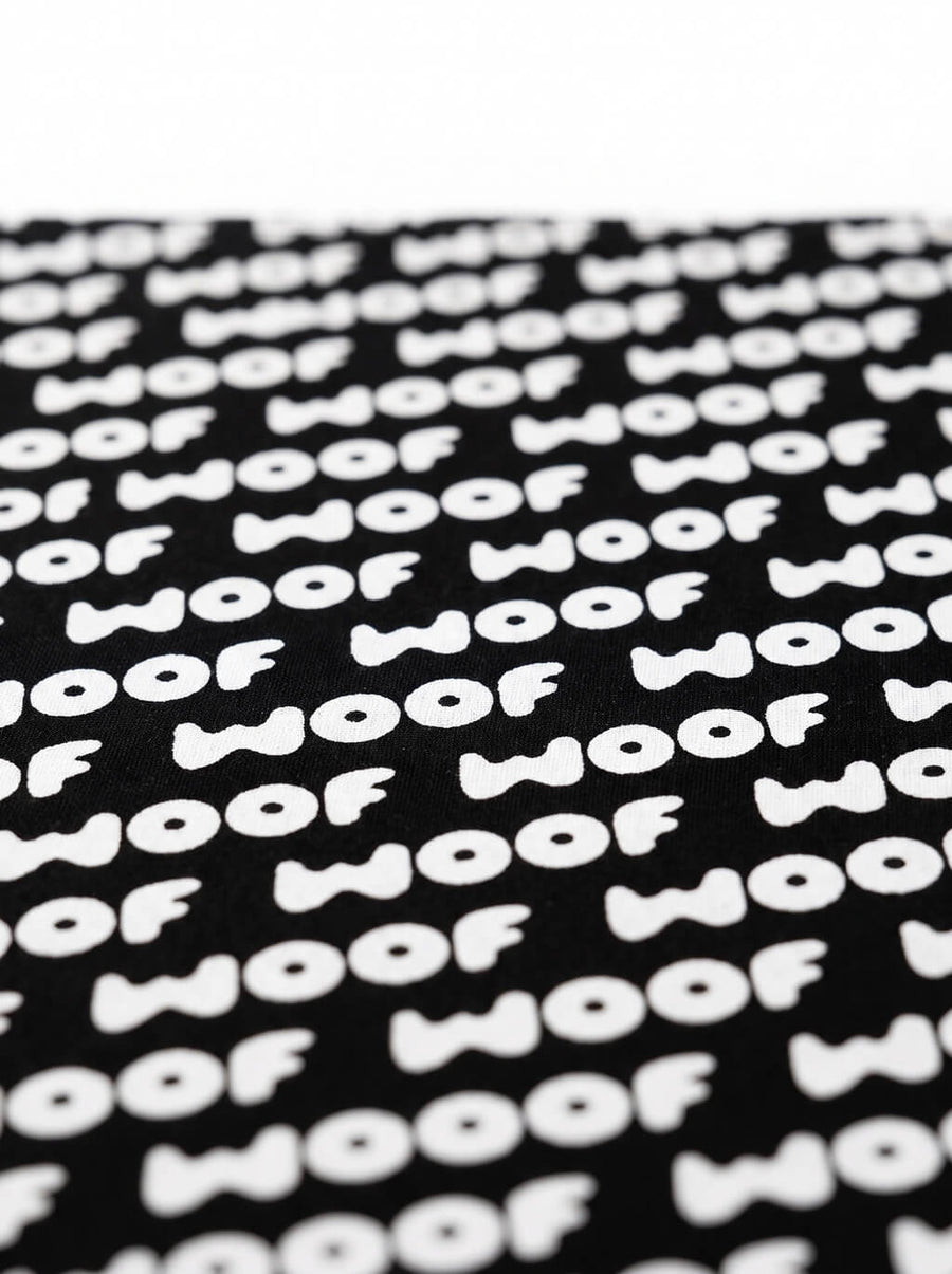 Close up of the WOOF logo on the black dog bandana