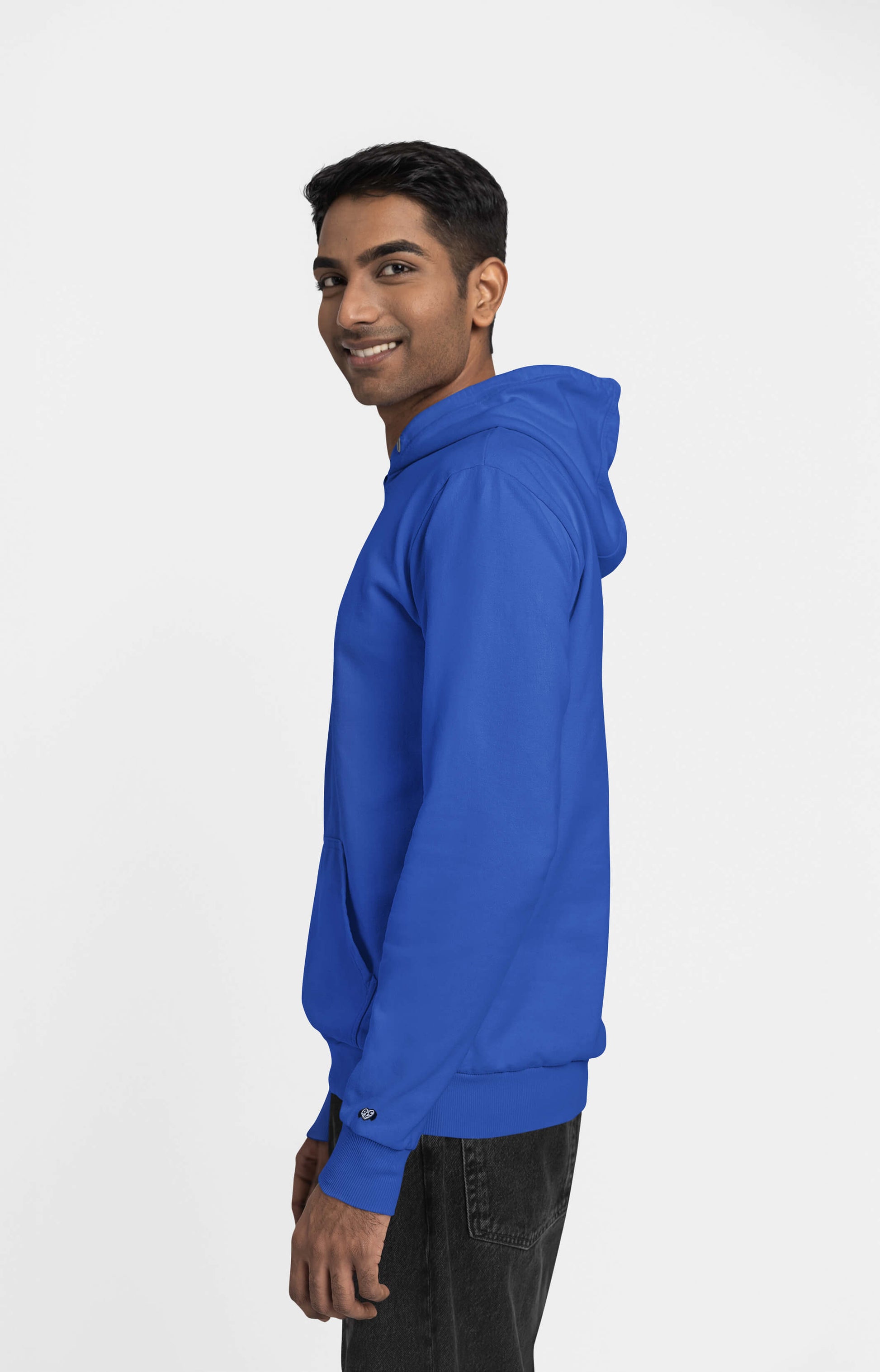 A man wearing the Unisex Dog Walker© Premium Hoodie by Dogloverclothing.com stands sideways, smiling against a plain white background. Sporting short dark hair and dark jeans, hes ready for everyday adventures.