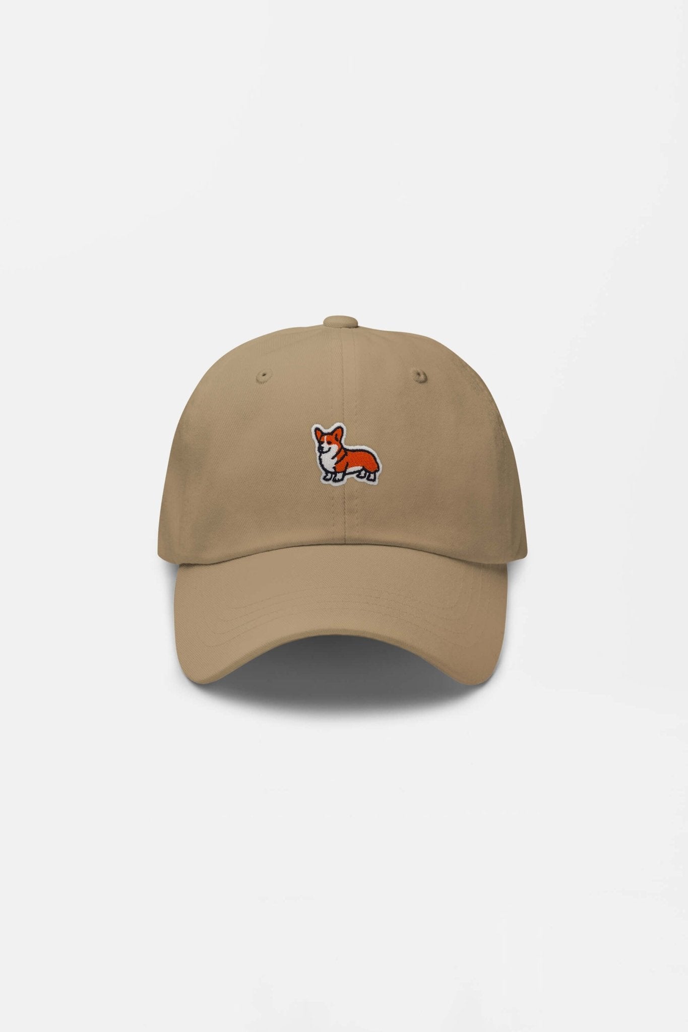 The Iconic Corgi Cap by Dogloverclothing.com is a beige hat with an embroidered orange and white corgi on the front, perfect for showing off your love of Corgis. Shown against a plain white background.