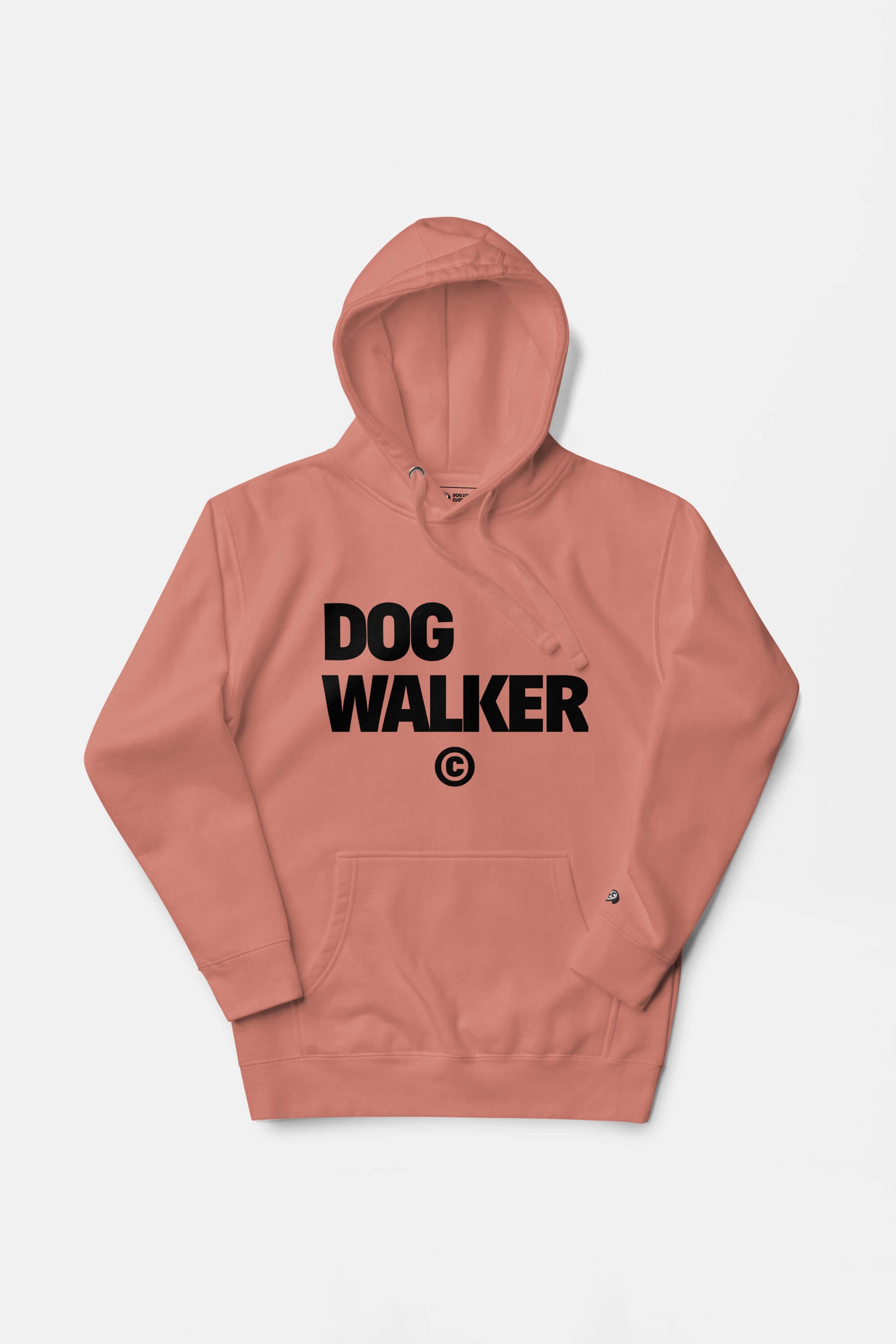 The Unisex Dog Walker© Premium Hoodie by Dogloverclothing.com is peach-colored with bold black DOG WALKER text on the front. It features a front pocket and drawstring hood, ideal for everyday adventures, displayed flat against a white background.