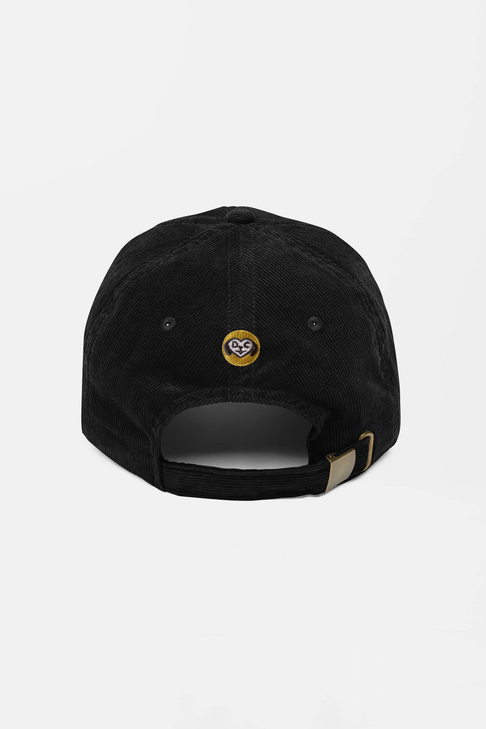 The Limited Dog Lover Corduroy Cap by Dogloverclothing.com is a black vintage cap shown from the back, featuring a small embroidered yellow and white circular logo above an adjustable strap with a brass-colored buckle.