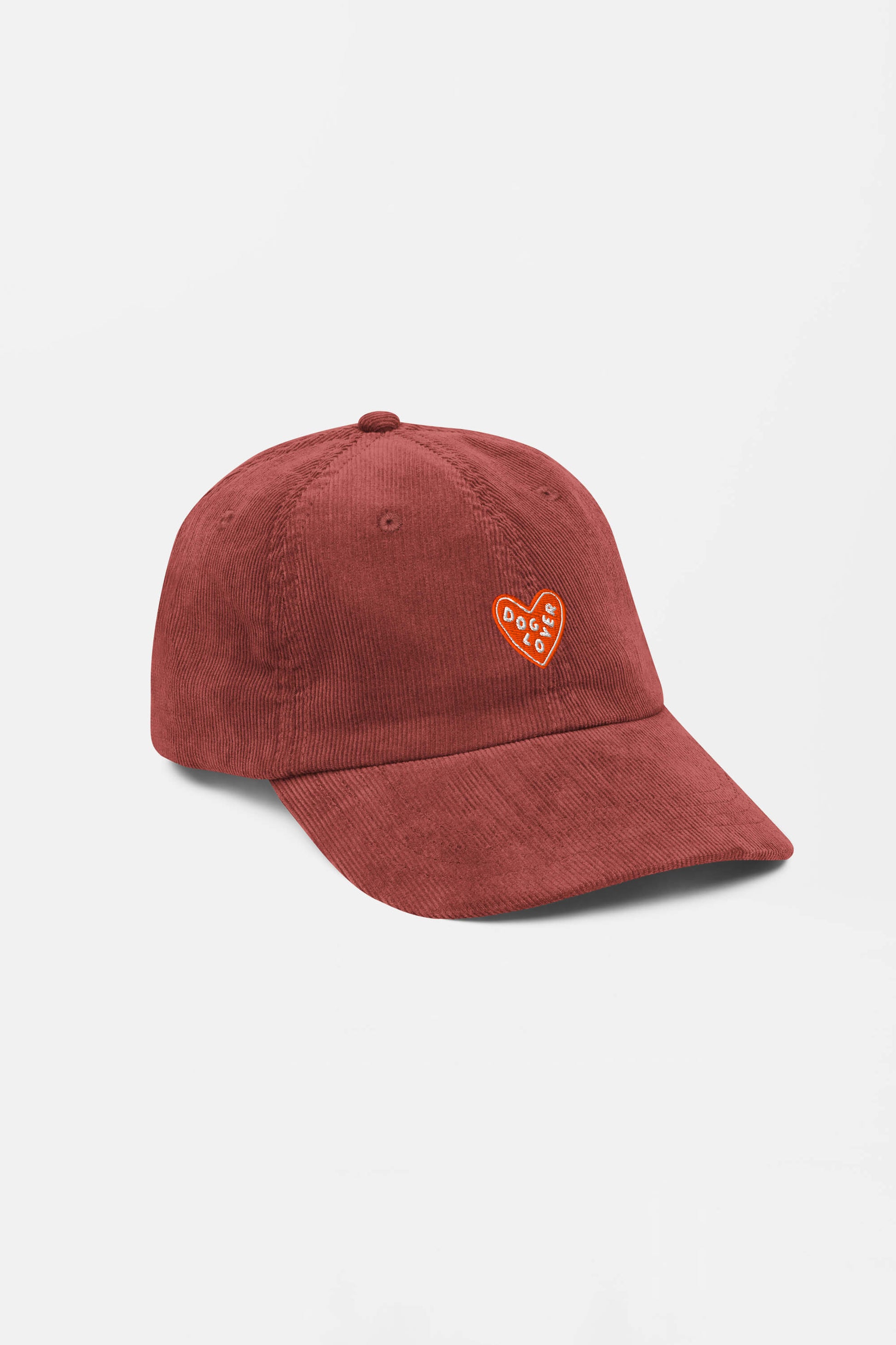 The Limited Dog Lover Corduroy Cap from Dogloverclothing.com is a rust-colored vintage hat with an adjustable fit and a small embroidered orange and white heart patch that reads DOG CLUB, shown on a plain white background.