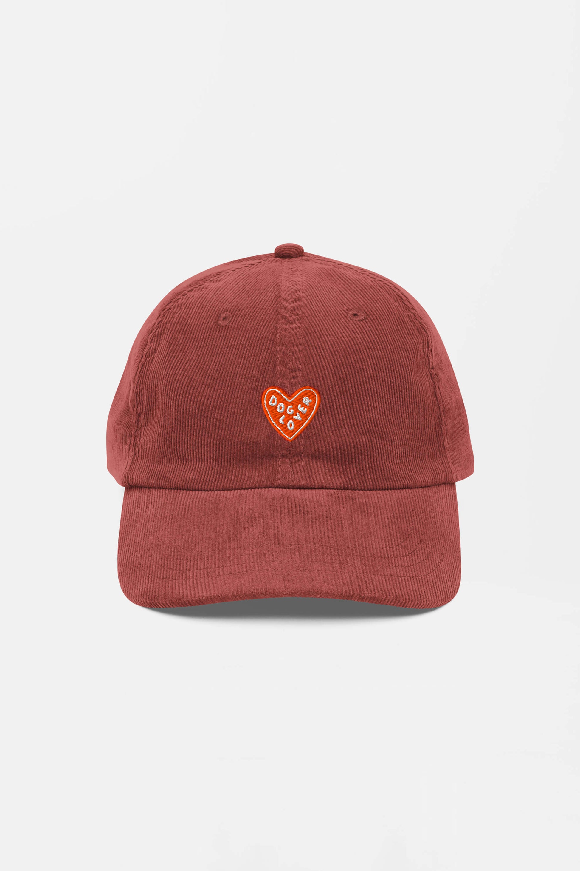 The Limited Dog Lover Corduroy Cap from Dogloverclothing.com is a rust-colored vintage hat with a small embroidered orange heart and DEDICATED in white. This adjustable cap is perfect for dog lovers and fans of casual style.