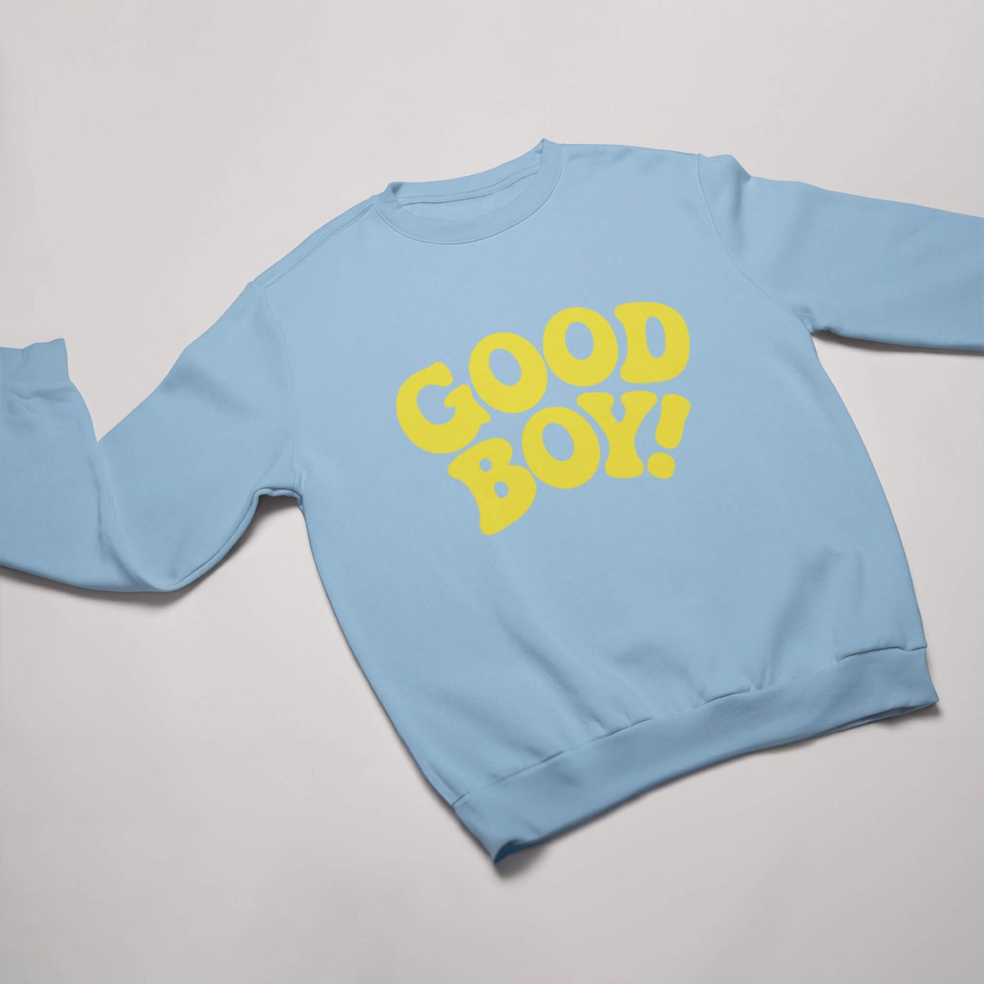 Light blue sweatshirt from Dogloverclothing.com featuring GOOD BOY! in bold yellow on the front, designed for dog lover enthusiasts—available as the Good Boy Sweater.