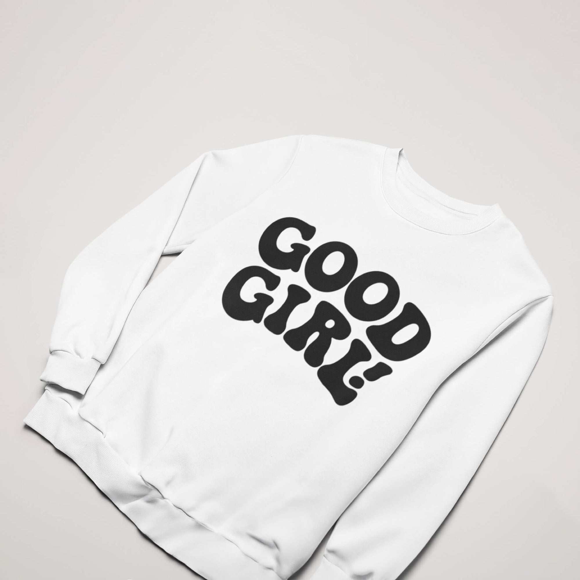 The Good Girl Sweatshirt from Dogloverclothing.com features bold black text on white, perfect for the dog lover in your life when laid flat on a light gray background.