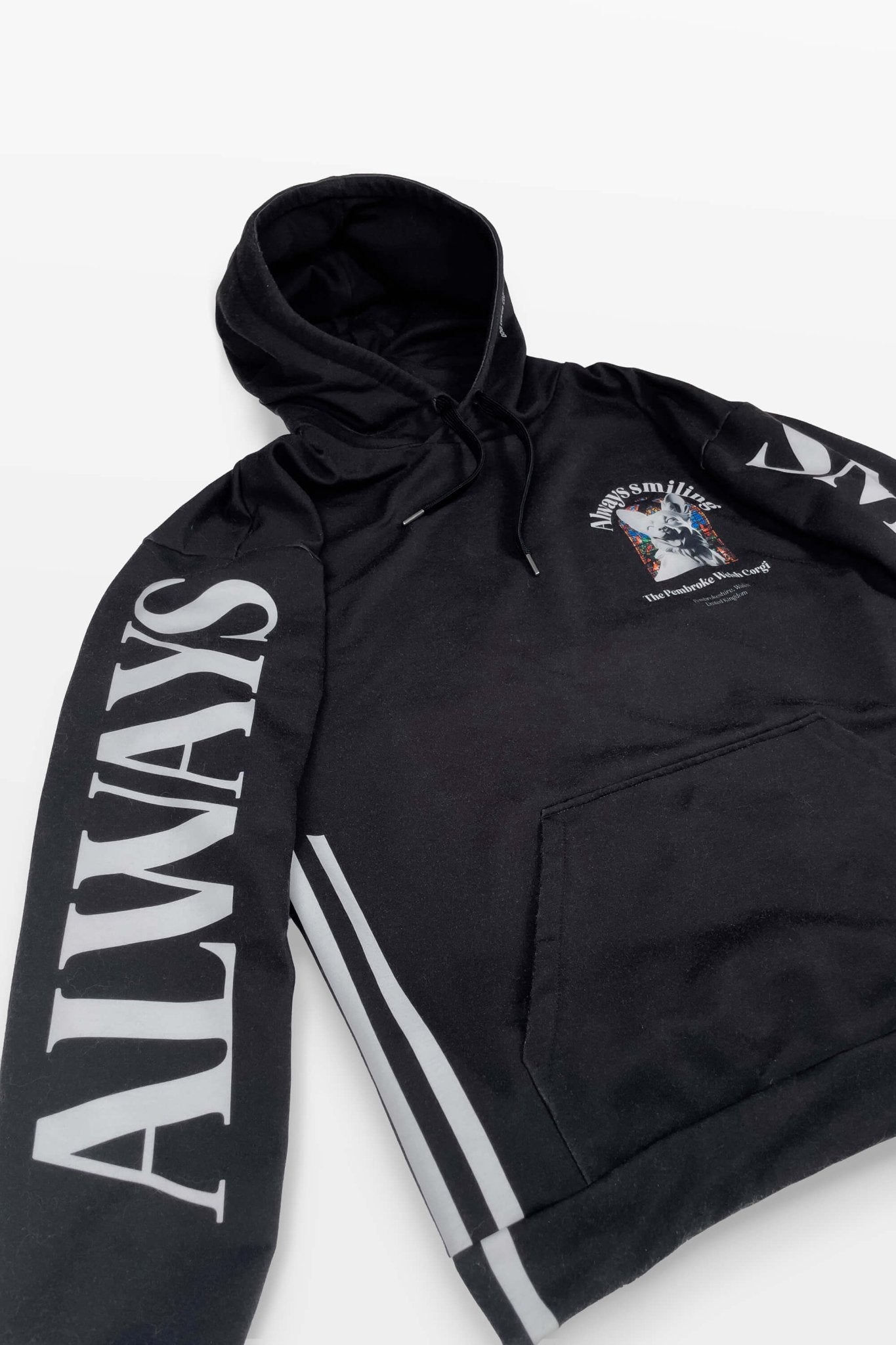 The Corgi Supreme Tribute Hoodie by Dogloverclothing.com features ALWAYS on the sleeves, a chest graphic, small text, and two vertical gray stripes on the sides. Crafted from recycled materials, it seamlessly combines style with an eco-friendly approach.