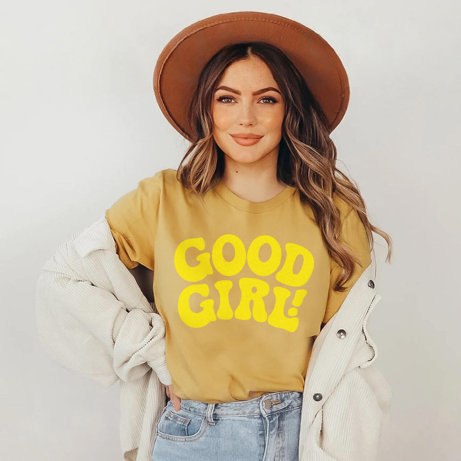 Model wearing the mustard Good Girl T-Shirt from WOOF