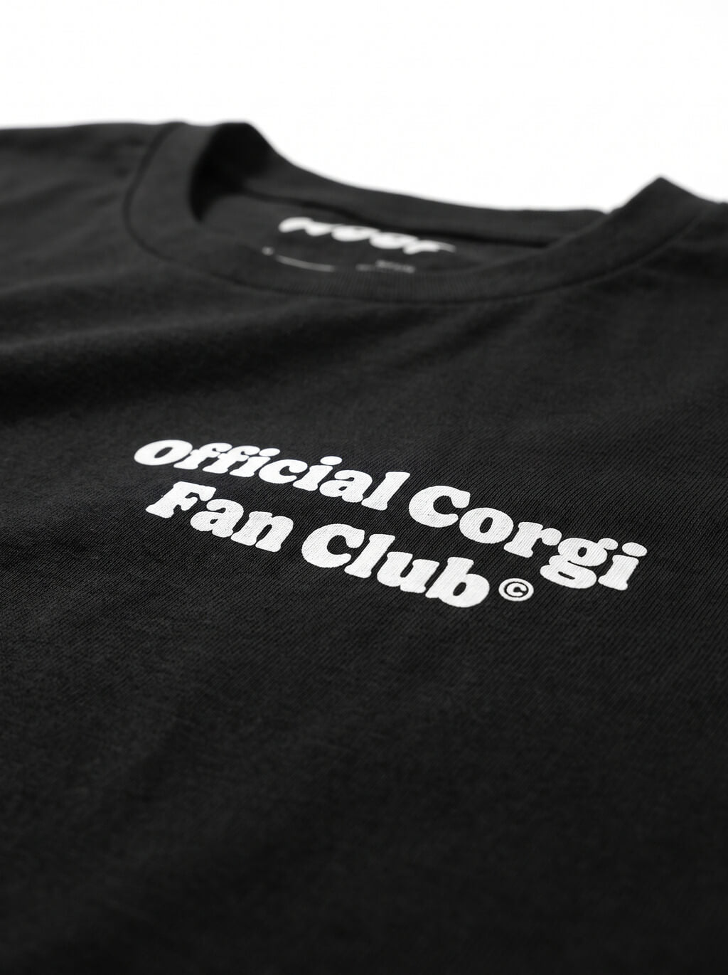 Close up of the front badge on the black Official Corgi Fan Club T-Shirt from WOOF