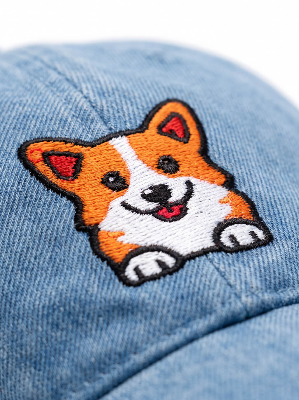 Close up of the corgi patch on the blue denim cap from WOOF