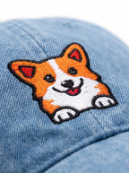 Close up of the corgi patch on the blue denim cap from WOOF