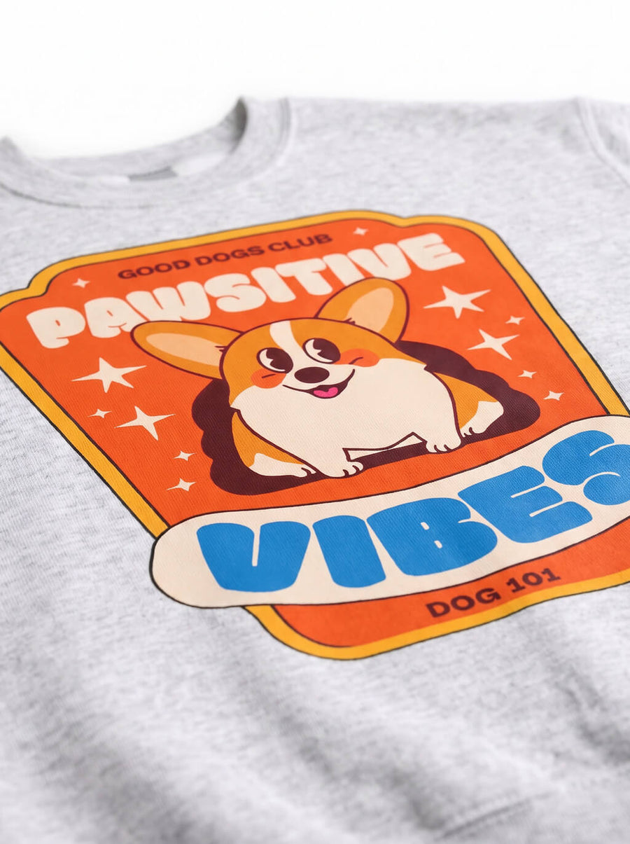 Close up of the print on the grey Pawsitive Vibes Corgi Sweatshirt from WOOF
