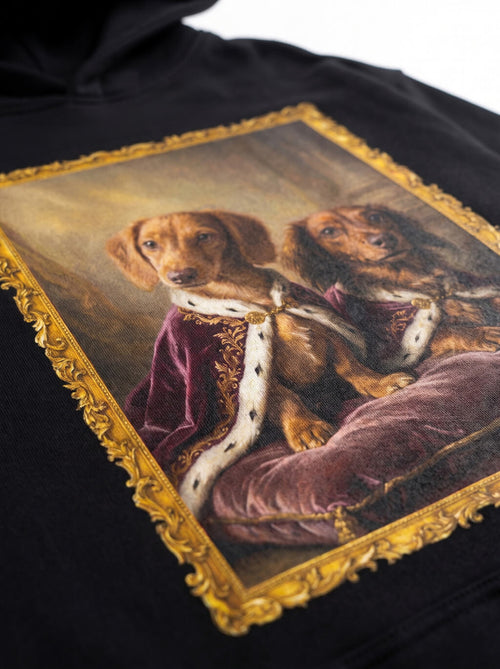Close up of the framed royal portrait print on the black hoodie from WOOF