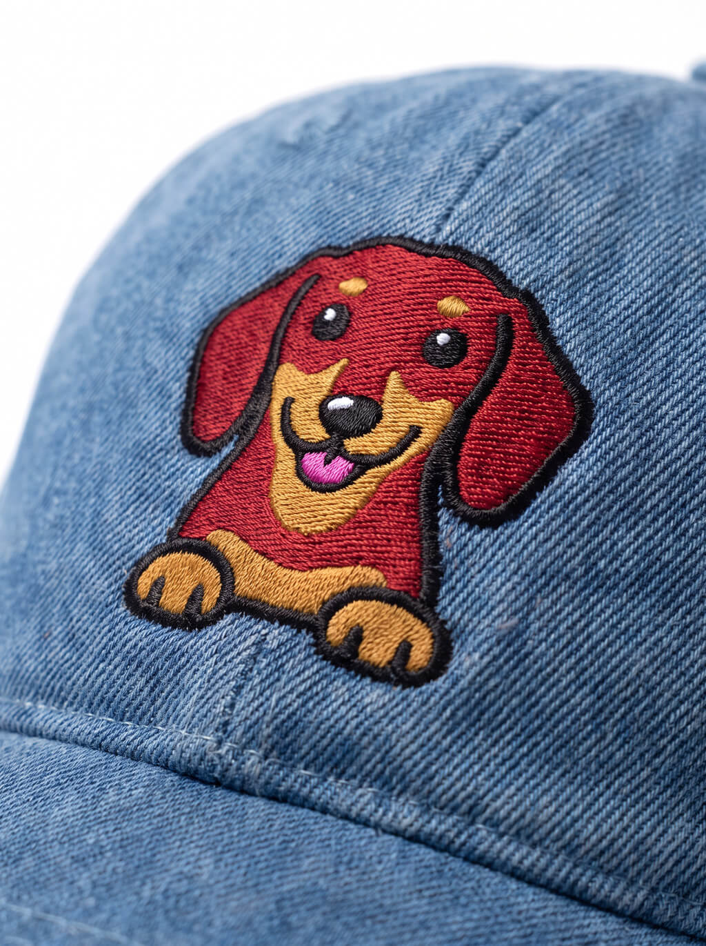 Close up of the dachshund embroidery on the denim cap from WOOF