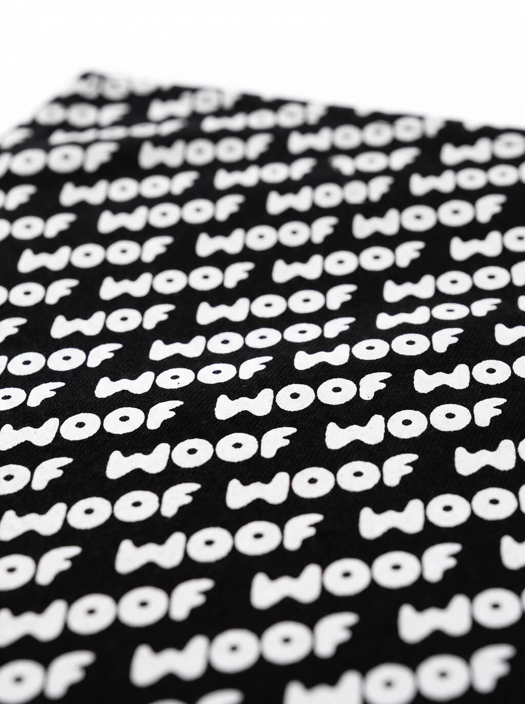 Fabric detail on the black WOOF Logo Dog Bandana