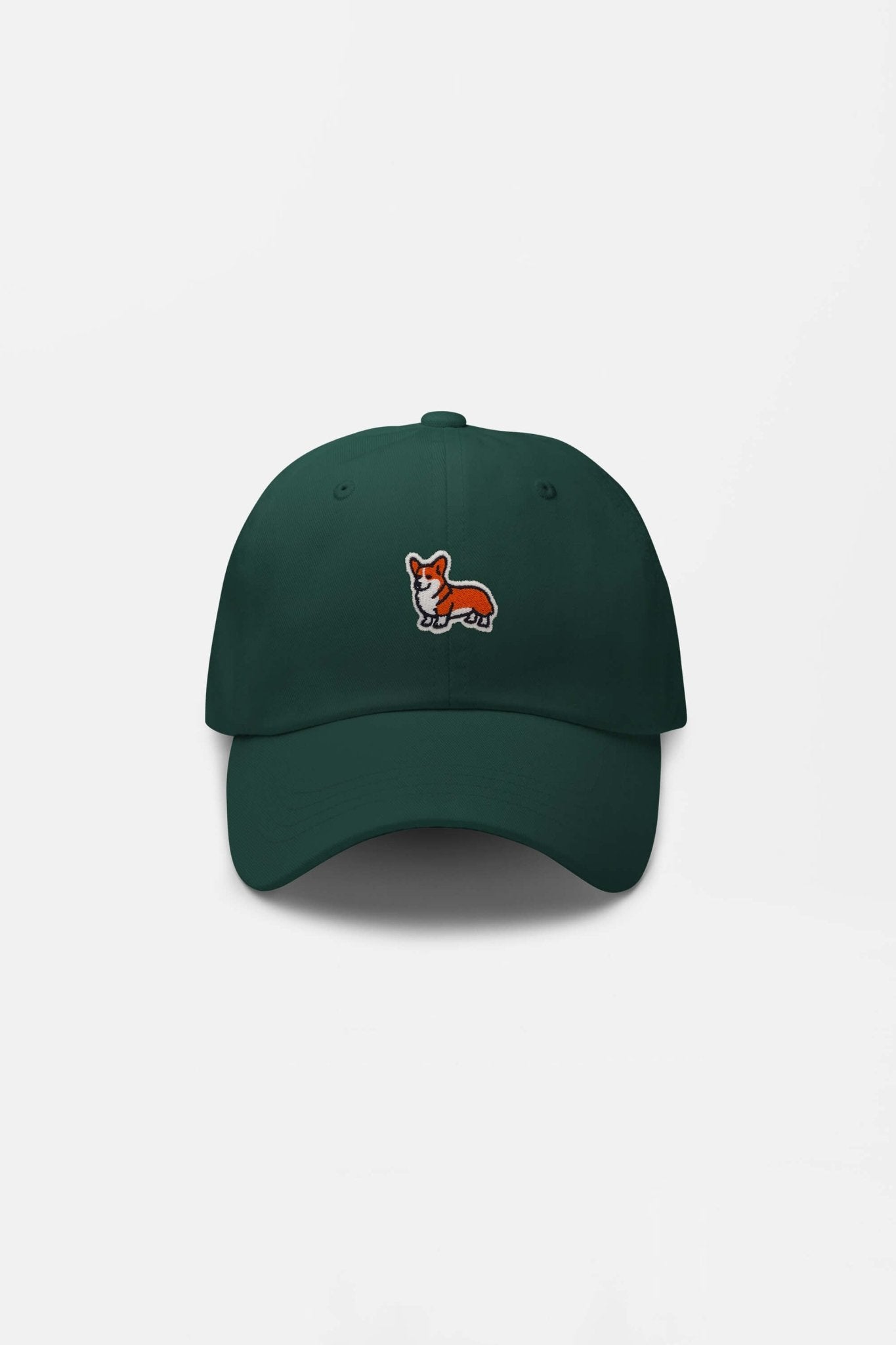 The Iconic Corgi Cap by Dogloverclothing.com is a dark green hat with a small embroidered orange and white corgi on the front, capturing true corgi cuteness. It is shown against a plain white background.