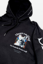 The Corgi Supreme Tribute Hoodie by Dogloverclothing.com is an eco-friendly black hoodie made from recycled materials, featuring a smiling dog illustration with stained glass-like colors and the text: Always Smiling - The Pembroke Welsh Corgi - Pembrokeshire, Wales, United Kingdom. Ideal for any Corgi enthusiast.