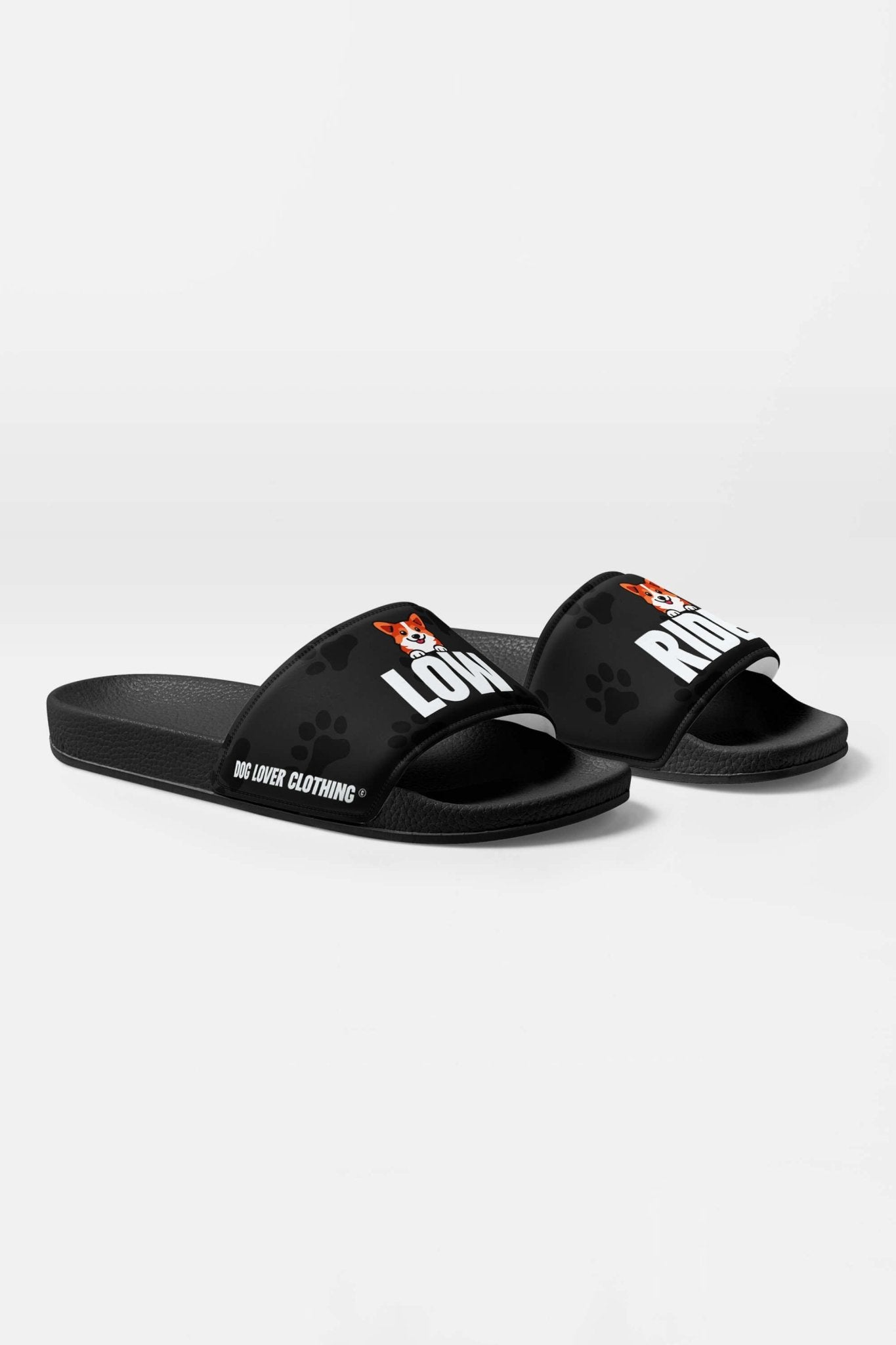Mighty Corgi Rider Slides by Dogloverclothing.com feature durable build, cartoon dog faces on the straps, DOG LOVER CLOTHING branding on the sides, subtle paw prints, and “LOVE” and “RIOT” text—perfect for fans of playful style.