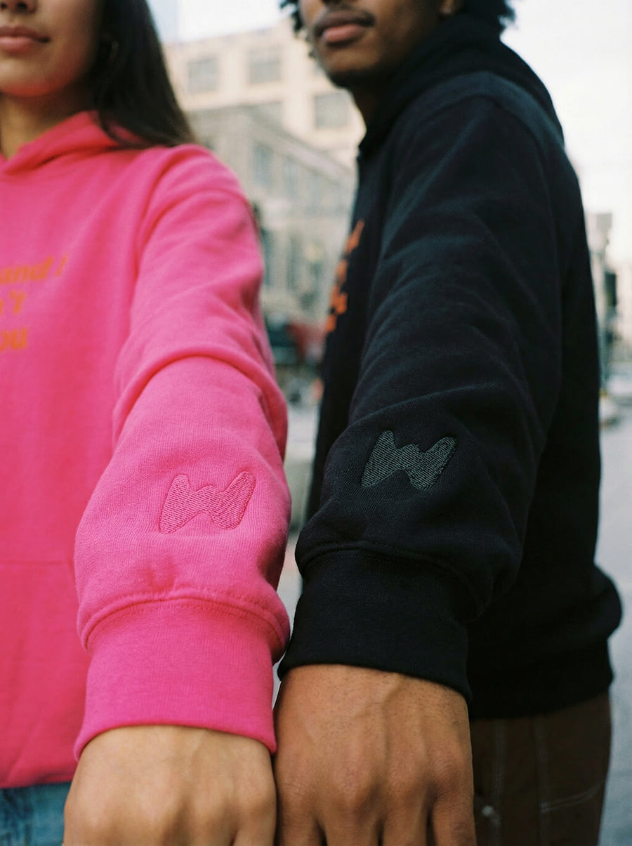Close up of the My Dog And I Talk embroidery on the pink hoodie from WOOF