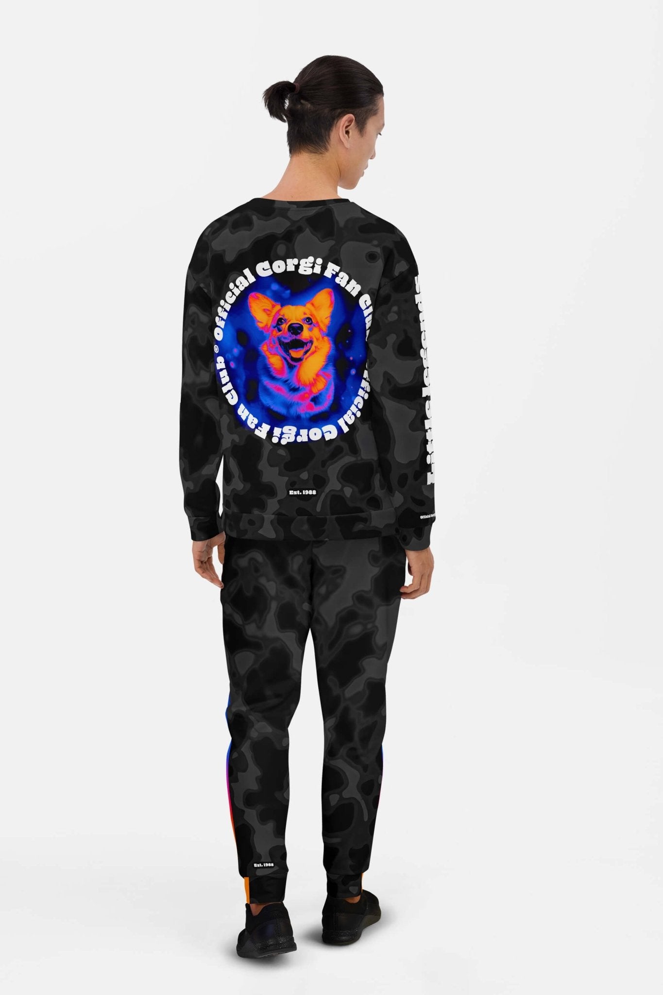 A person with long hair in a ponytail wears the Dogloverclothing.com Official Corgi Fan Club© Elite Camo Sweatshirt, featuring a vibrant smiling corgi and Official Corgi Fan & Proud—a must-have for true club members.