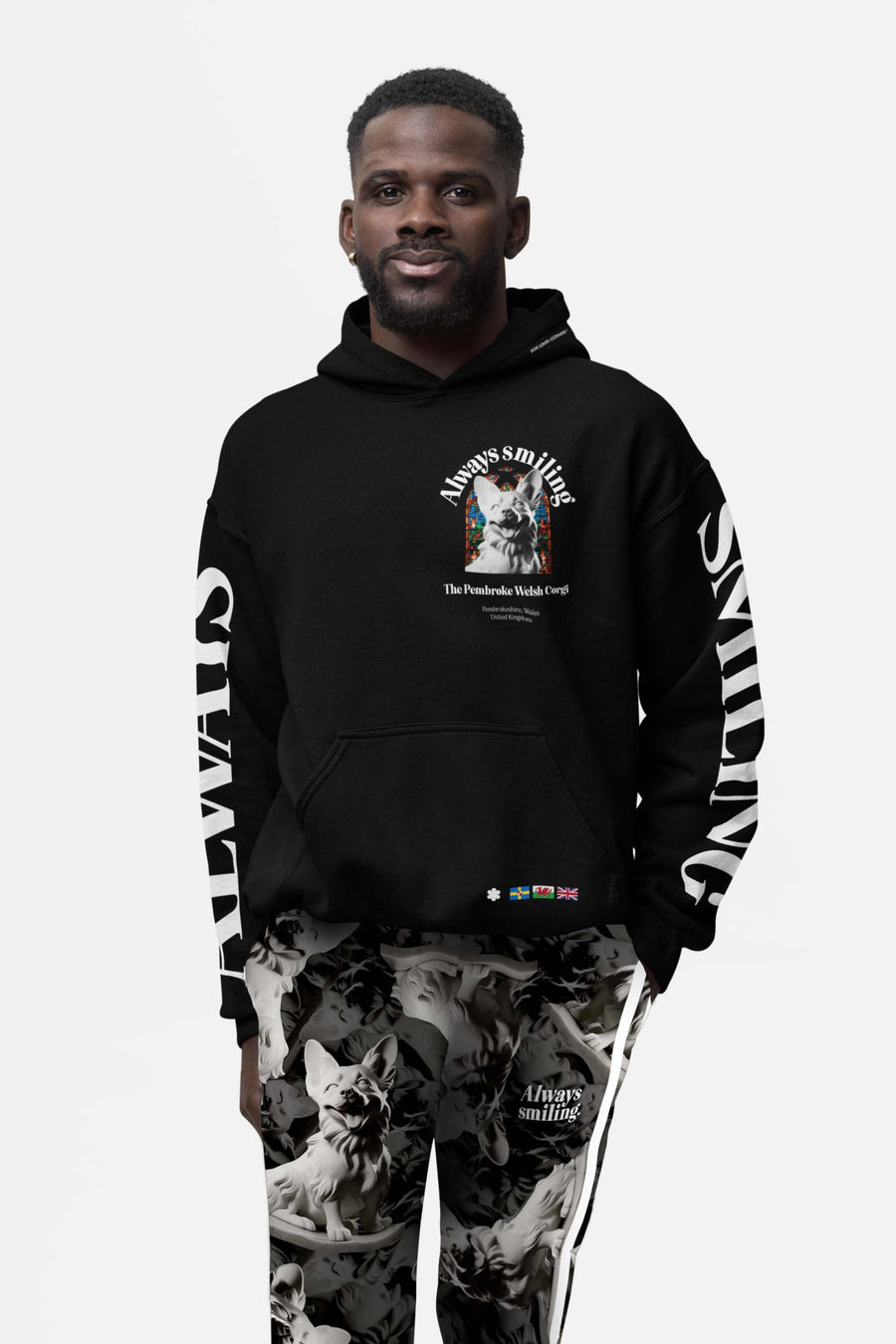 Model in the Corgi Supreme Tribute Hoodie from WOOF, front view with chest and sleeve print