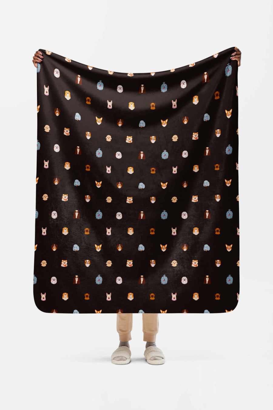 Doggy Dreams Sherpa Blanket from WOOF draped over a sofa