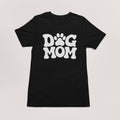 The Dogloverclothing.com Dog Mom T-Shirt features DOG MOM with a paw print for the O, great for pairing with dog bandanas or adding to your cherished dog-themed collection.