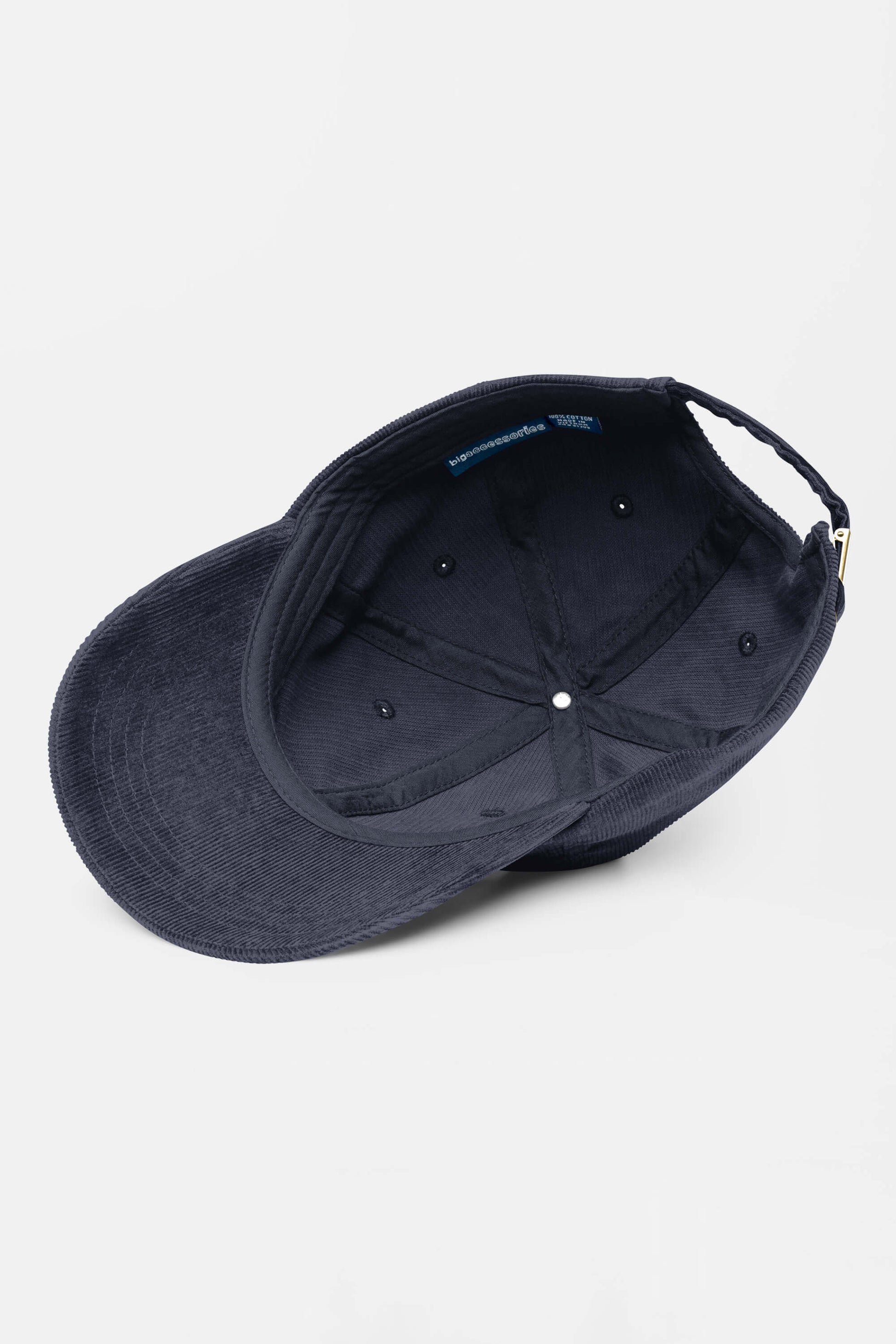 The Limited Dog Lover Corduroy Cap from Dogloverclothing.com is pictured upside down on a plain white background, showcasing its inner lining, stitching, and adjustable strap for a customizable fit.